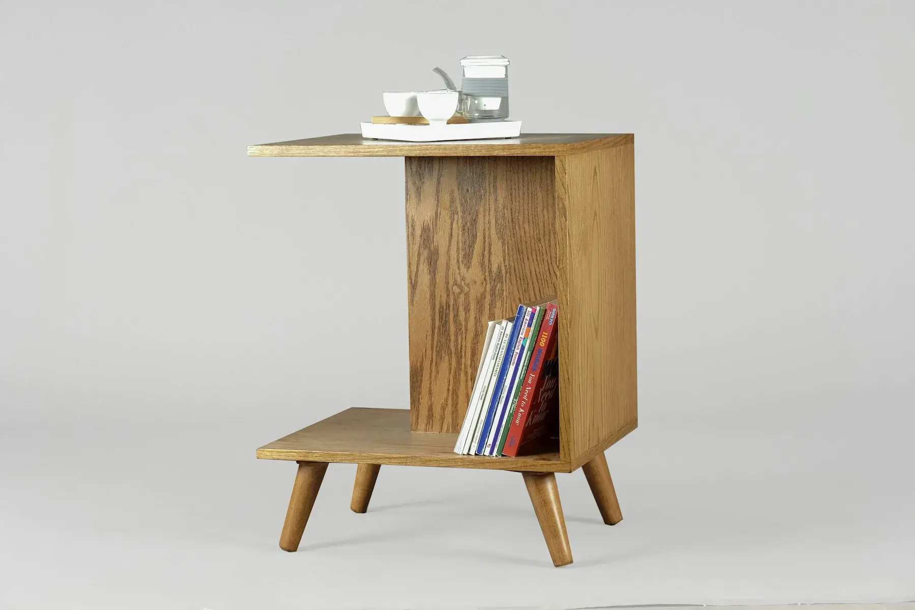 Wooden side table with books