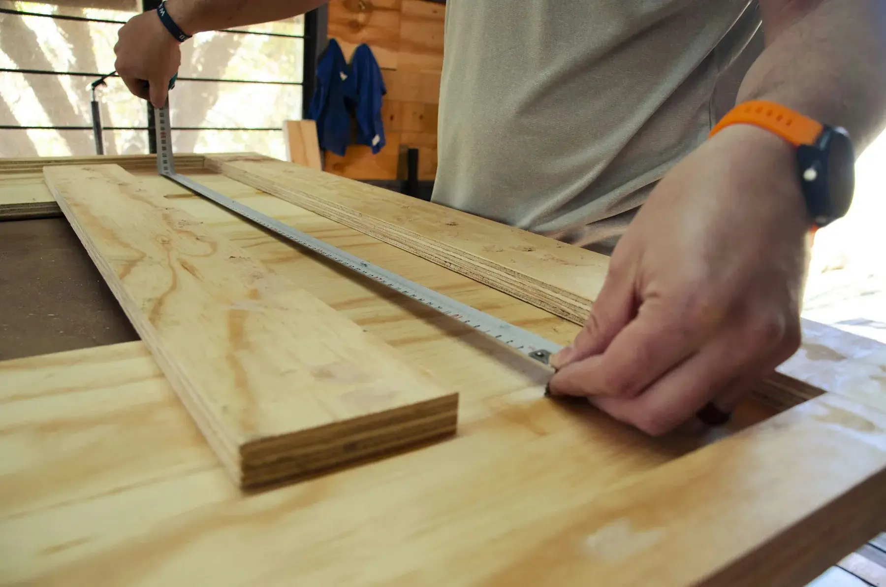 Artisan measuring a timber plank